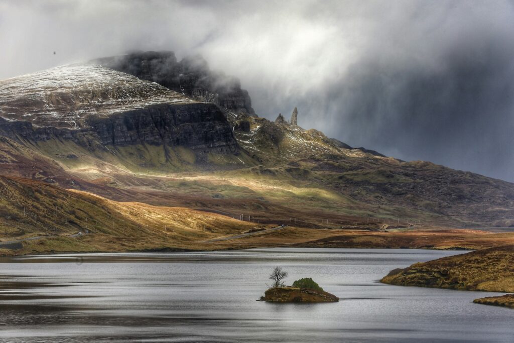 Mist over the hills and still water of the Scottish highlands